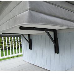 an outdoor storage area with a mattress on the top and bottom shelf attached to it