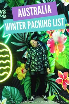 a woman standing in front of a wall with flowers and plants on it, text reads australia winter packing list