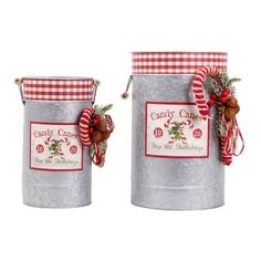 two metal buckets with christmas decorations on them