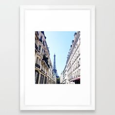 the eiffel tower is seen from between two buildings