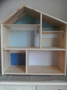 an unfinished dollhouse with blue and white walls