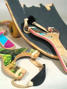 an old skateboard and other items are laying on the floor next to each other