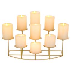 six lit candles are arranged on a stand