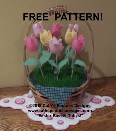 a basket filled with flowers sitting on top of a wooden table