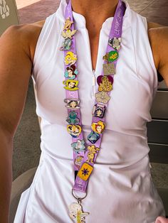 a woman wearing a purple lanyard with cartoon characters on it