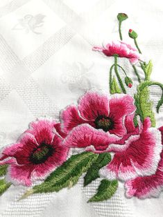 pink flowers on white fabric with green stems