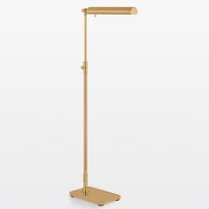 a gold metal floor lamp on a white background