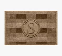 a door mat with the letter s on it and a circle design in the center