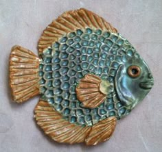 a ceramic fish is sitting on a table