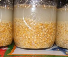 three jars filled with food sitting on top of a table