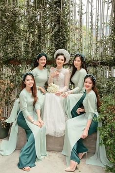 the bridesmaids are all dressed in mint green dresses and matching headpieces