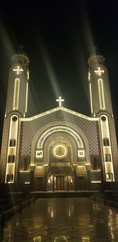 a large church with lights shining on it's sides