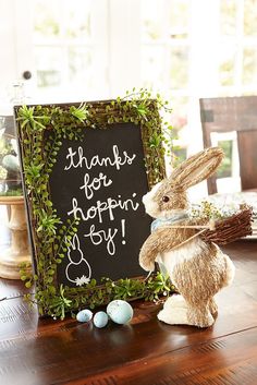 a sign that says thanks for hoppin'n joy next to a stuffed bunny