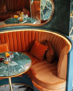 an orange and blue booth with two round tables