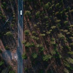 an aerial view of a road surrounded by trees