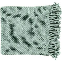 a green knitted blanket with fringes