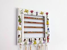 a white frame with beads hanging from it's sides