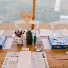 the table is set with books, pens and markers