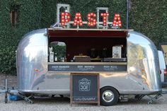 a food truck with the word taco written on it's side and lights lit up