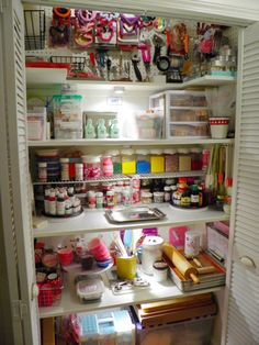 an organized pantry with lots of clutter and crafting supplies on the shelves in it