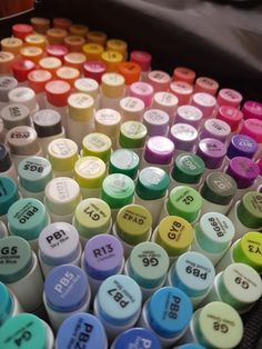 many different colors of paint are in a container with the numbers painted on each side