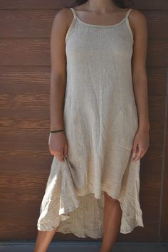 "We're inspired by sustainable hemp clothing that puts the earth and the people that make it first. Our personal relationship with our manufacturer in India allows us to stay true to what is important. Using organic materials, sustainable production, and fairly compensating our skillful tailors. You can wear this hemp dress anywhere or anytime and feel great wearing it. Included in every dress is our belief for a more sustainable and fair future.  Buy HEMP - heal the planet. 🌱 FEATURES ✔️Spaghetti straps ✔️Scoop neck ✔️Tie in back ✔️Asymmetrical, short in front and long in back  ✔️Below the knee length ✔️Machine washable (separately on gentle cycle and hang dry) ✔️100% Hemp from Nepal 🌱 SIZING:  SMALL Bust 34\"-35\" Waist 28\"-32\" Hip 46\" Length 49\"  MEDIUM Bust 36\"-37\" Waist 29\"-3 Sleeveless Neutral Linen Midi Dress, Asymmetrical Hem Linen Beach Dress, Beach Linen Dress With Asymmetrical Hem, Linen Beach Dress With Asymmetrical Hem, Sleeveless Natural Color Summer Dress, Natural Sleeveless Summer Dress, Natural Color Sleeveless Summer Dress, Beige Linen Sleeveless Dress For Beach, Summer Dress Short