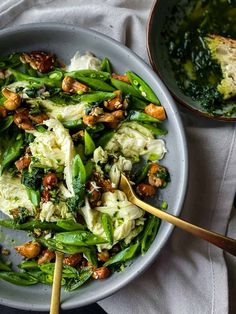 a bowl filled with pasta and vegetables next to a plate full of broccoli