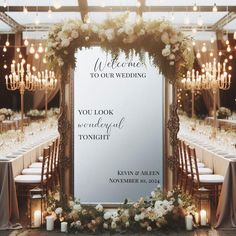 a wedding sign with flowers and candles in front of a large mirror that says, welcome to your wedding you look wonderful tonight