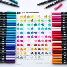 the art dual brush pens are lined up on top of each other with different colors