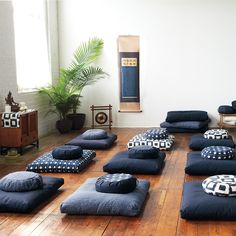 a room with many pillows on the floor