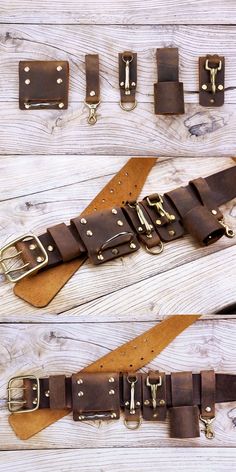 several different types of leather belts on a wooden surface with metal buckles and brass hardware