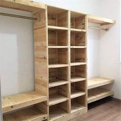 an empty room with wooden shelves and benches