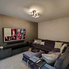 a living room filled with furniture and a flat screen tv mounted to the side of a wall