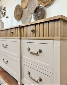 a white dresser with drawers and knobs in a room