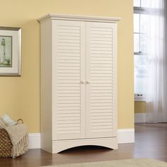 a white cabinet sitting in the corner of a room