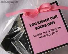 a pink and black gift bag filled with chocolate covered oreo cookies that says you knock our socks off thanks for a totally amazing year