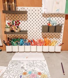 there are many pencils and markers in the holder on the table next to each other