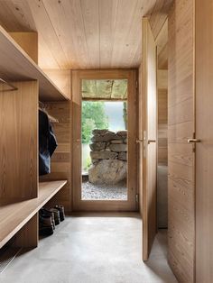 an open wooden closet with shoes on the shelves