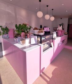 there is a pink counter in the middle of this room with lots of food on it