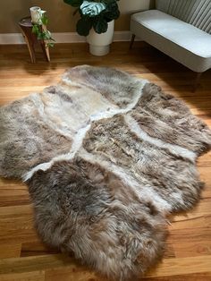 Size: 74” x 70” Truly one-of-a-kind. Made from six beige ivory sheepskin pelts, professionally sewn to last a life-time. Use this as a throw, blanket, couch cover, rug, bed cover, and more. Hair type: The fur on each of these pelts is soft, plush and has different textures and lengths throughout. The color is a natural ivory. Each pelt is exclusive and one-of-a-kind. There's never a duplicate!The Benefits of Sheepskins:- Wool is incredible at regulating body heat- Helps to relieve aches and pains- Resistant to dirt and bacteria- Hypo-allergenic (and help soothe skin rashes like eczema and more )- Adds warmth and texture to your homeOur ethically sourced pelts come from small organic farmers whose sheep roam miles each day through hilltops and mountains. They are softened with animal fats a Blanket Couch Cover, Sheepskin Blanket, Throw Blanket Couch, Organic Nursery, Blanket Couch, Skin Rashes, Sacred Spaces, American Living, Couch Cover