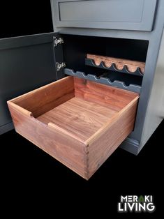 a wooden box sitting in the middle of a kitchen counter with wine racks above it