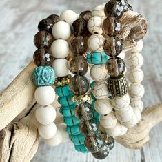 Mix, match & stack these gorgeous beaded bracelets to create your own classic~vintagy~beachy~boho stack! Made with creamy Calcutta style marble, faceted smoky quartz, fluted turquoise magnesite, creamy white wood and gold accents. 10mm beads. These bracelets are so versatile and can be dressed up or down for any occasion. Choose 1-5 bracelets, see picture for number labels.  **Please note number choice(s) in checkout**  *Comes in 7 inch length for average 6.5 inch wrist unless custom size is noted in check out   *Feel free to note wrist size and preferred fit (loose or snug) if desired *Comes gift-giving-ready with a Salty Sunshine branded tag, crinkle paper & a pretty sheer drawstring bag              *Free shipping $35 & up! Let's be friends! Favorite our Etsy shop and follow Salty Sunsh Turquoise Stackable Stretch Bracelet With Round Beads, Turquoise Stretch Bracelet With Round Beads, Turquoise Stretch Bracelet With Stackable Round Beads, Turquoise Stackable Beaded Bracelets With Round Beads, Bohemian Turquoise Crystal Bracelet With Spacer Beads, Turquoise Bohemian Crystal Bracelet With Faceted Beads, Bohemian Turquoise Crystal Bracelet With Faceted Beads, Spiritual Turquoise Stretch Bracelet With Faceted Beads, Bohemian Turquoise Stretch Bracelet With Faceted Beads