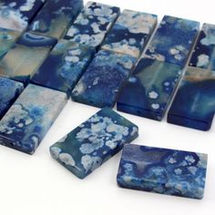 several pieces of blue and white glass sitting on top of a table next to each other