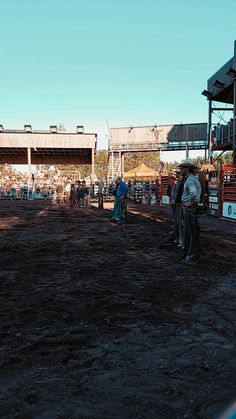 people are standing in the dirt at an event