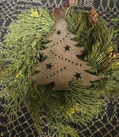 a wooden christmas tree ornament sitting on top of a table