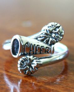 a close up of a ring on a table with the word cheer written in it