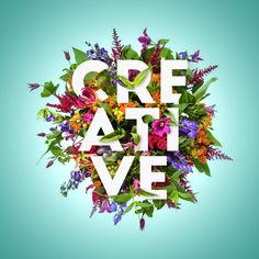 the words creative are surrounded by colorful flowers and leaves on a blue background with white letters