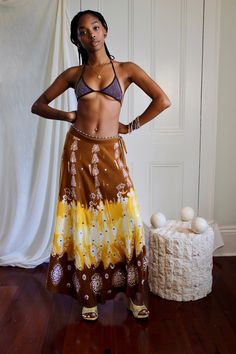 "Vintage maxi skirt in a gorgeous sunshine yellow and chestnut brown shades with silver sequin embellishments on the front. Has zip closure at size and drawstring waist and can be worn high or low waisted depending on measurements/desired fit.  Fits up to a 27\" waist." Bohemian Long Sarong With Batik Print, Bohemian Batik Print Beach Skirt, Bohemian Long Wrap Skirt With Batik Print, Bohemian Festival Skirt With Batik Print, Summer Bohemian Batik Print Skirt, Bohemian Batik Print Skirt For Summer, Bohemian Batik Print Skirt For Festival, Bohemian Batik Print Summer Skirt, Bohemian Batik Print Festival Skirt