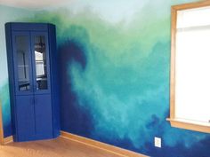 an empty room painted with blue and green paint