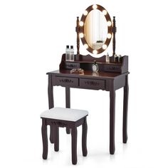 a vanity table with stool and lighted mirror